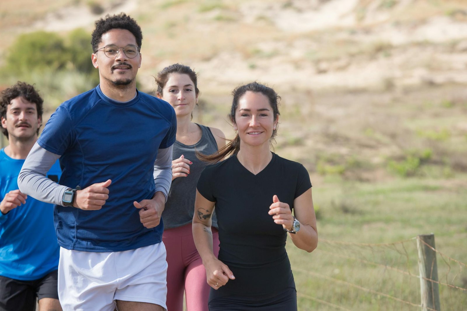 A group of diverse friends jogging outdoors together in Portugal, promoting fitness.
