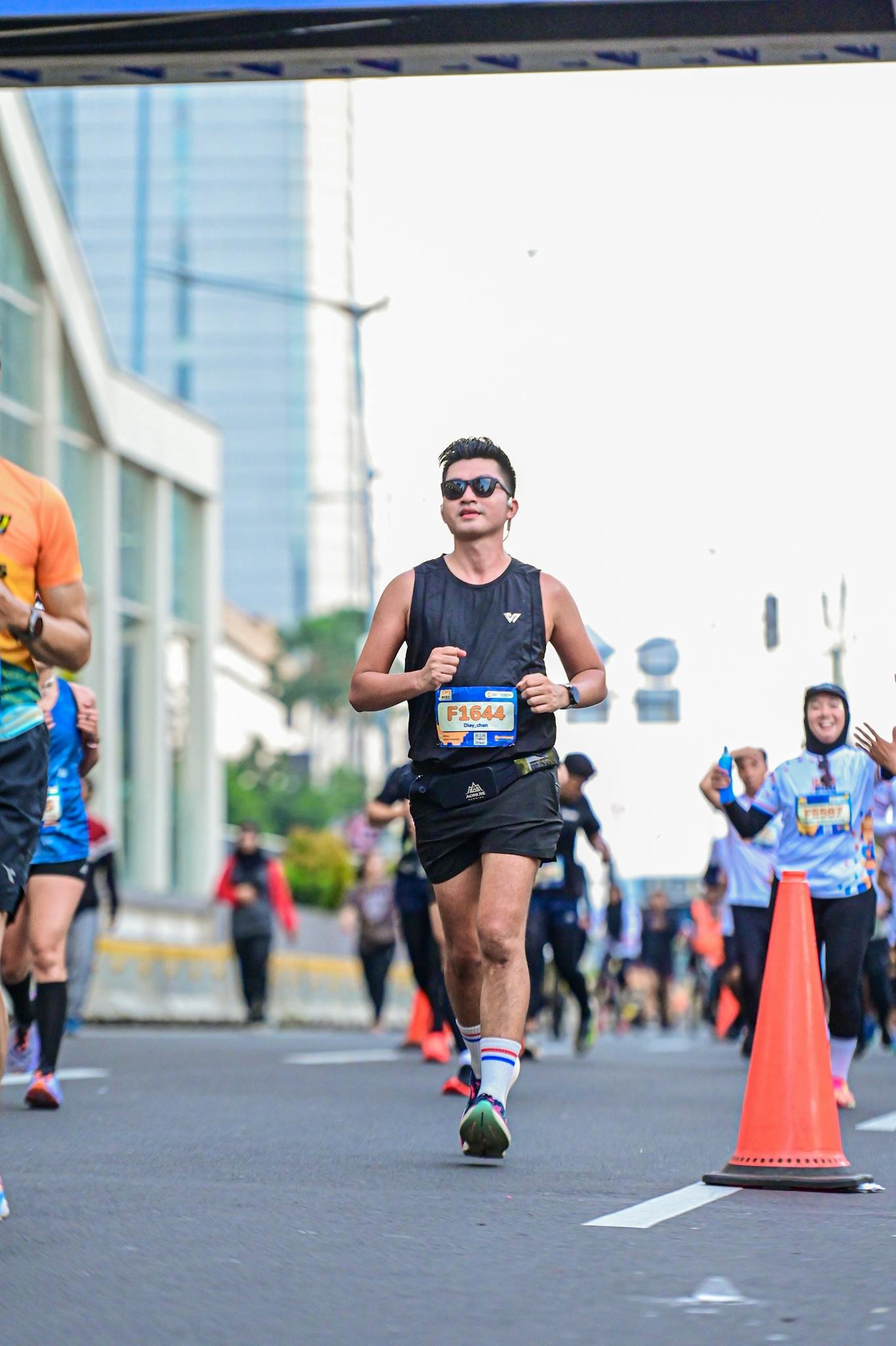 Male runner in city marathon event, showcasing athletic perseverance and urban fitness.